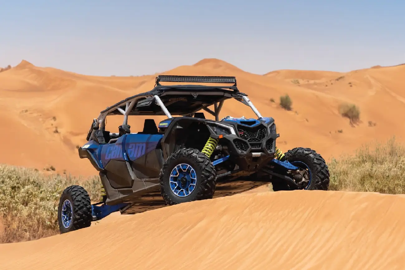 Blue Can-Am buggy on the desert dunes