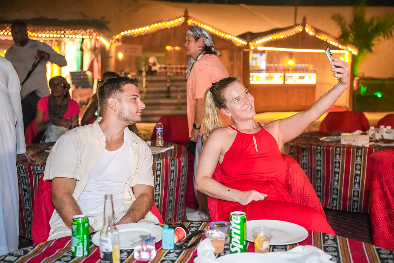 Couple enjoying dinner at an evening desert camp in Dubai