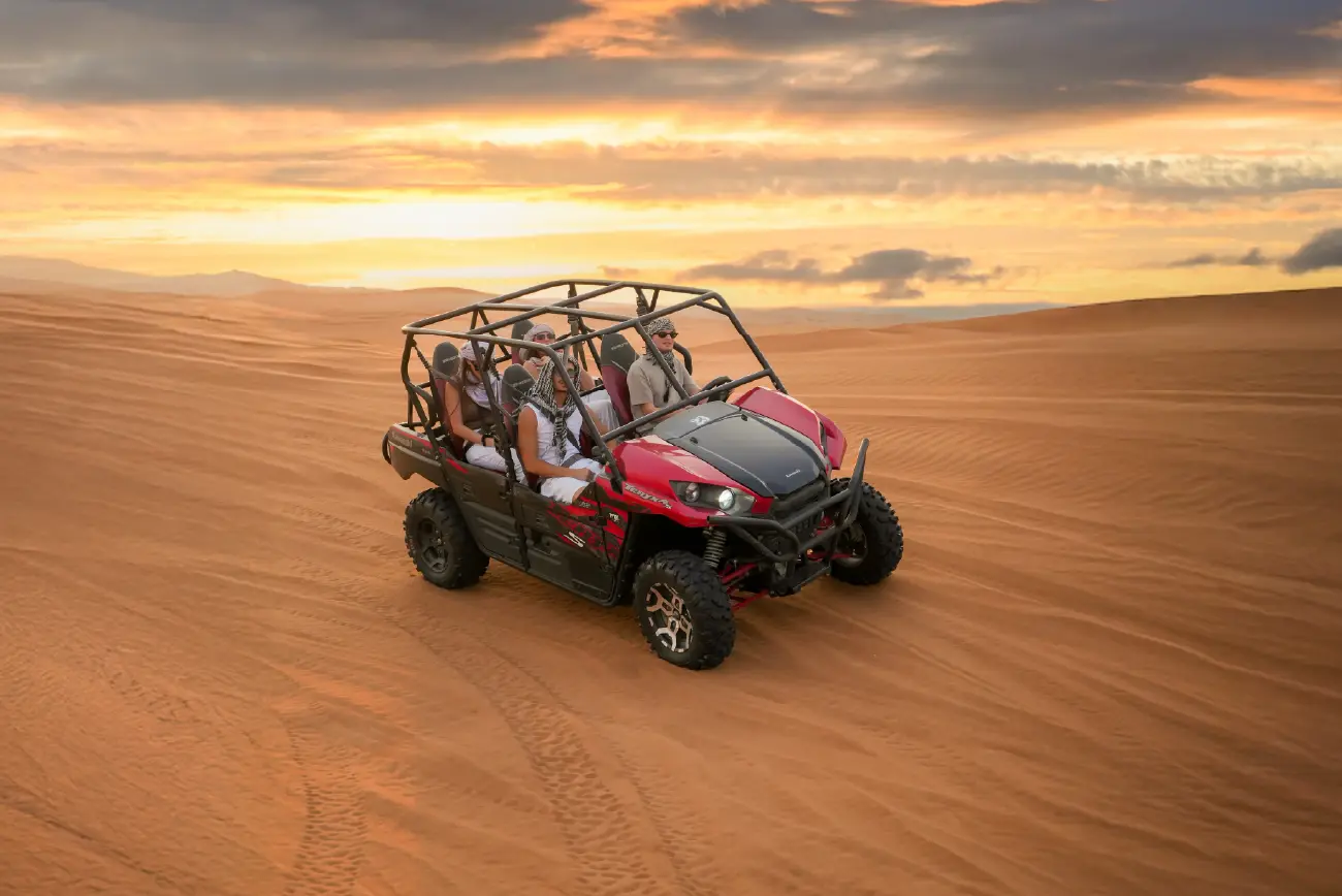 Kawasaki buggy on the dunes at sunset